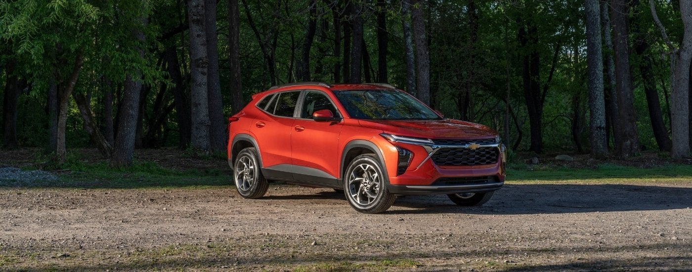 Orange 2024 Chevy Trax parked in a gravel lot