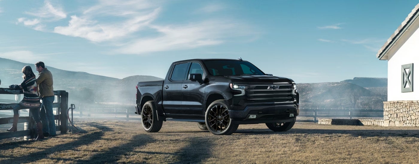 A black 2025 Chevy Silverado 1500 High Country parked on a ranch.