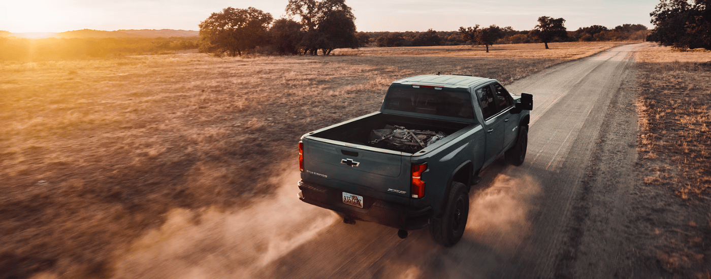 Green 2026 Chevy Silverado 2500 HD ZR2 driving down a dusty trail