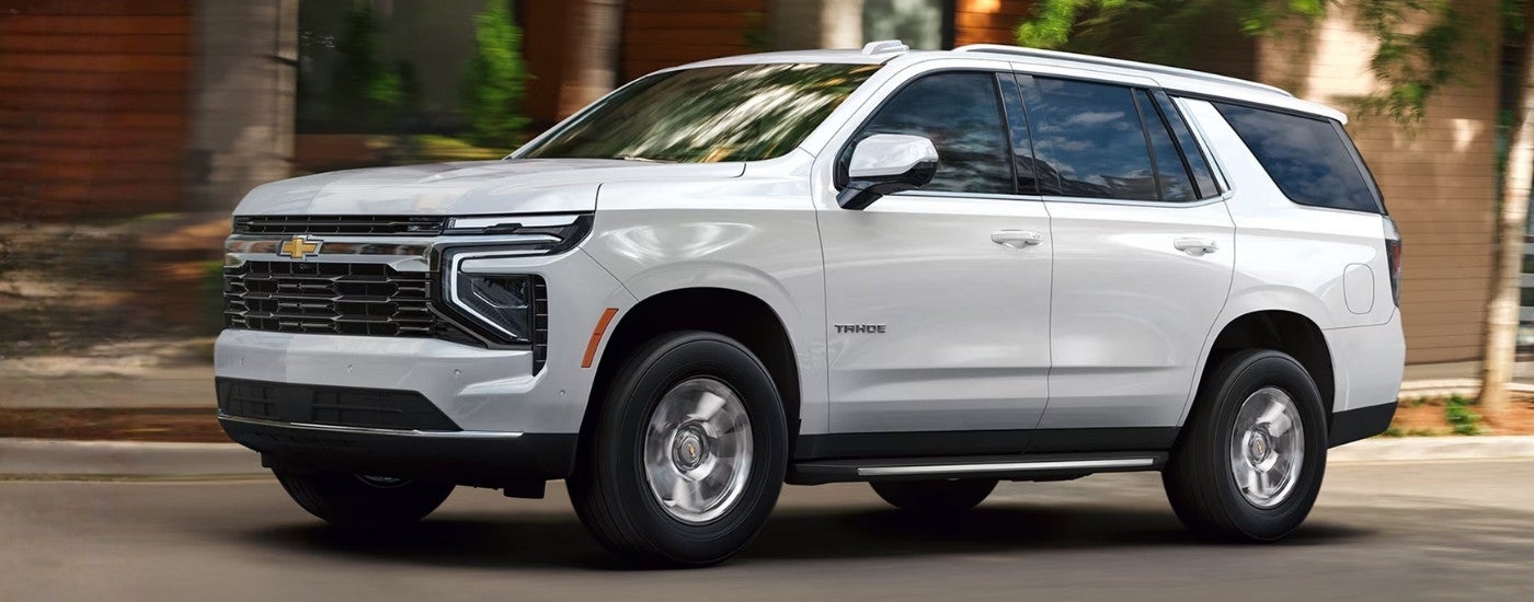 White 2026 Chevy Tahoe driving through a city