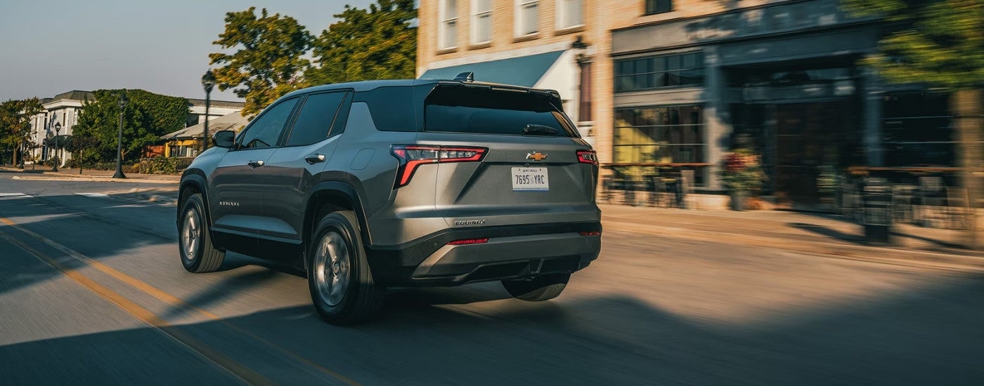 A gray 2026 Chevy Equinox LT shown driving from rear.