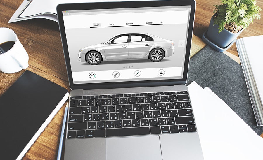 Online car shopping on laptop